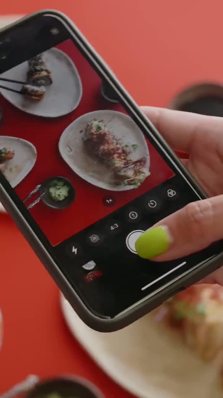 Creator photographing sushi on a phone
