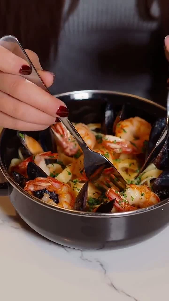 Close up of a seafood pasta dish being served
